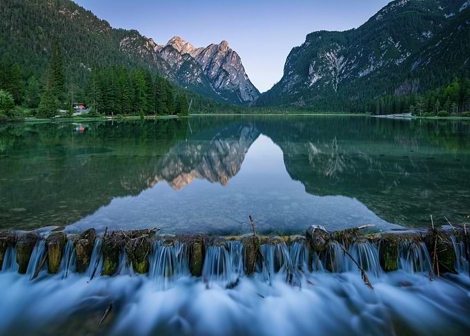 Mountain Lake Reflection with Waterfall