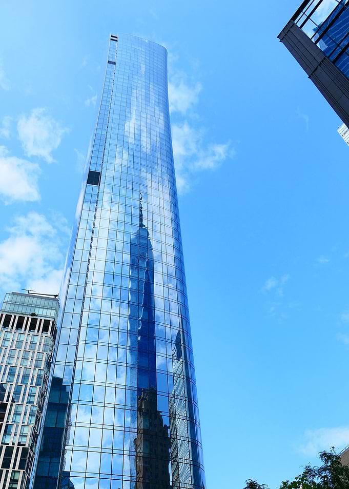 Modern glass skyscraper against blue sky
