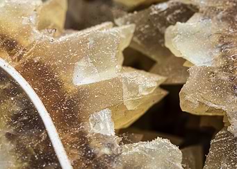 Macro shot of calcite (CaCO3) crystals filling an ammonite chamber