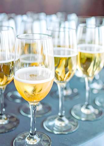 Champagne flutes filled with bubbly beverage