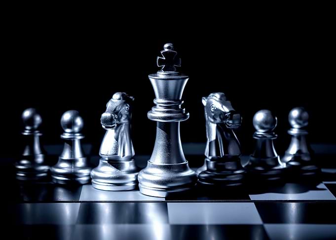 Silver Chess Pieces on Chessboard