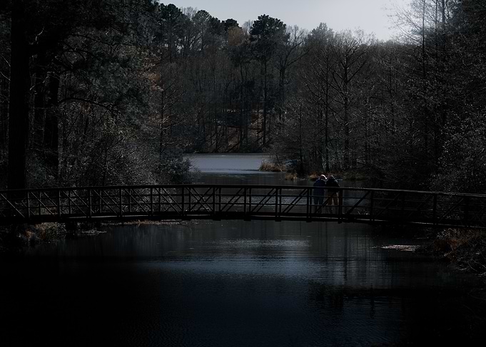 Bridge over water with two people