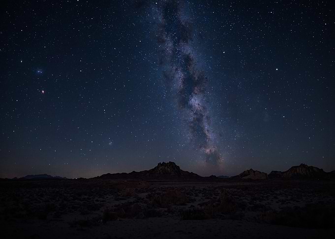 Milky Way over a dark landscape