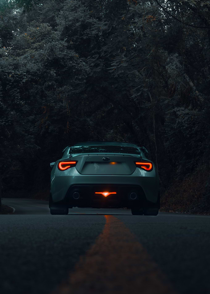 Car on Road with Forest Background