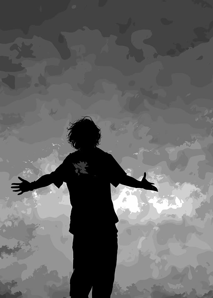 Silhouette with outstretched arms against sky