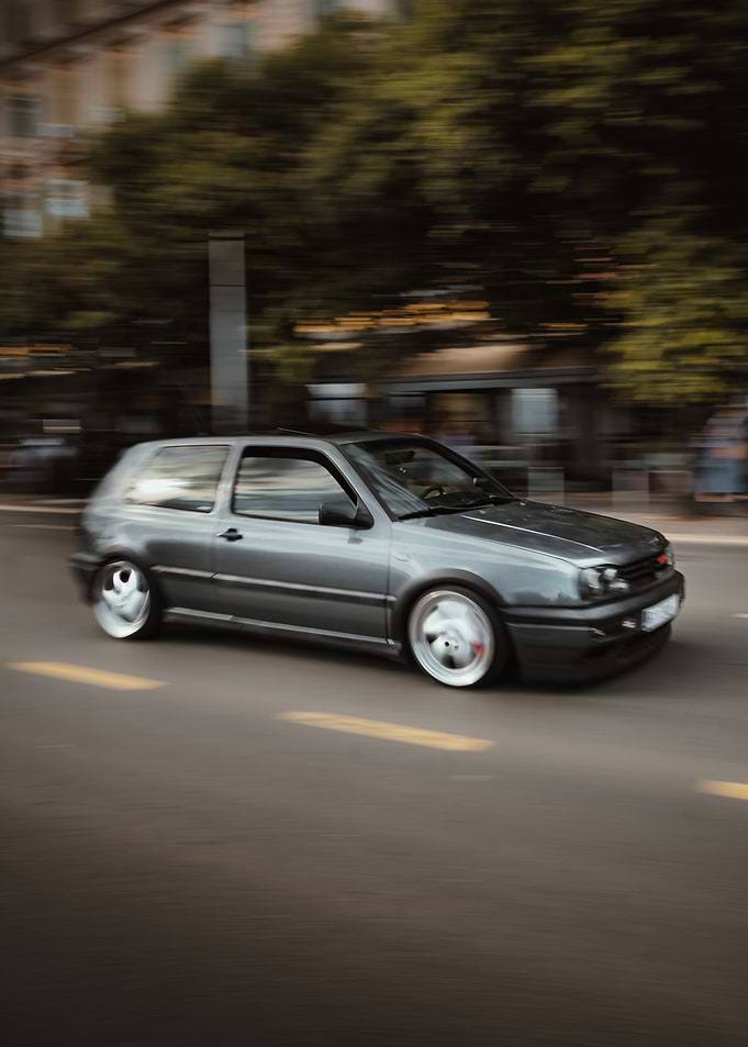 Gray Car Speeding on City Road