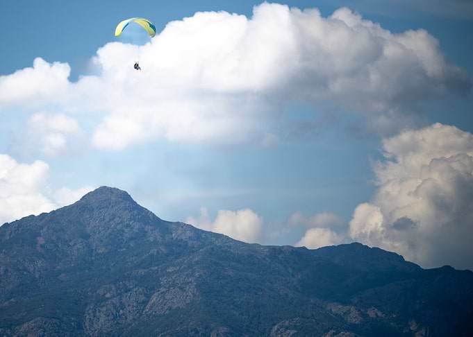 Paragliding over Mountain Landscape