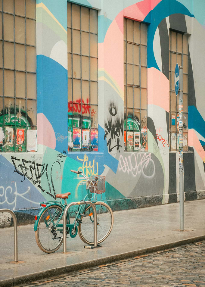 Turquoise Bicycle Parked Against Graffiti Wall Pastel