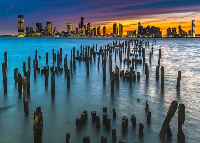 cityscape at sunset with wooden pilings