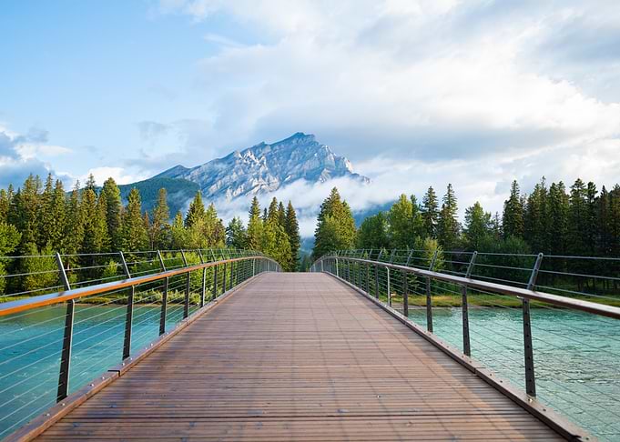 bridge over river with mountain view