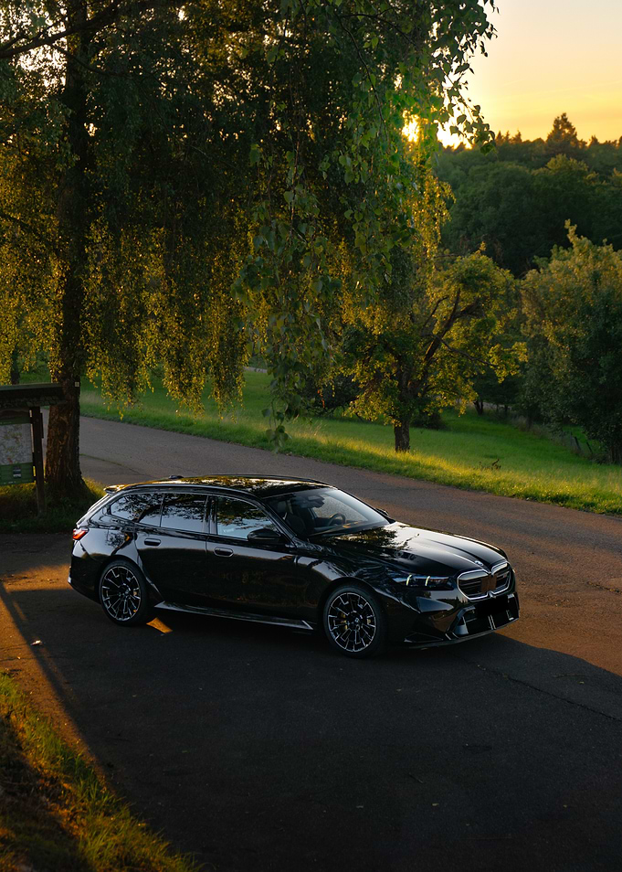 Black BMW M5 Touring on Country Road