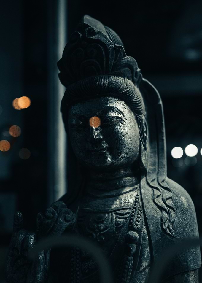 Stone Buddha Statue with Bokeh Lights