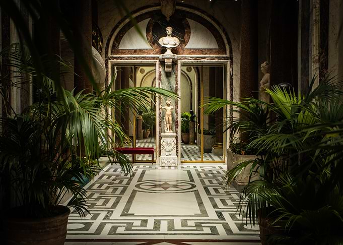 Elegant Hallway with Statues and Plants