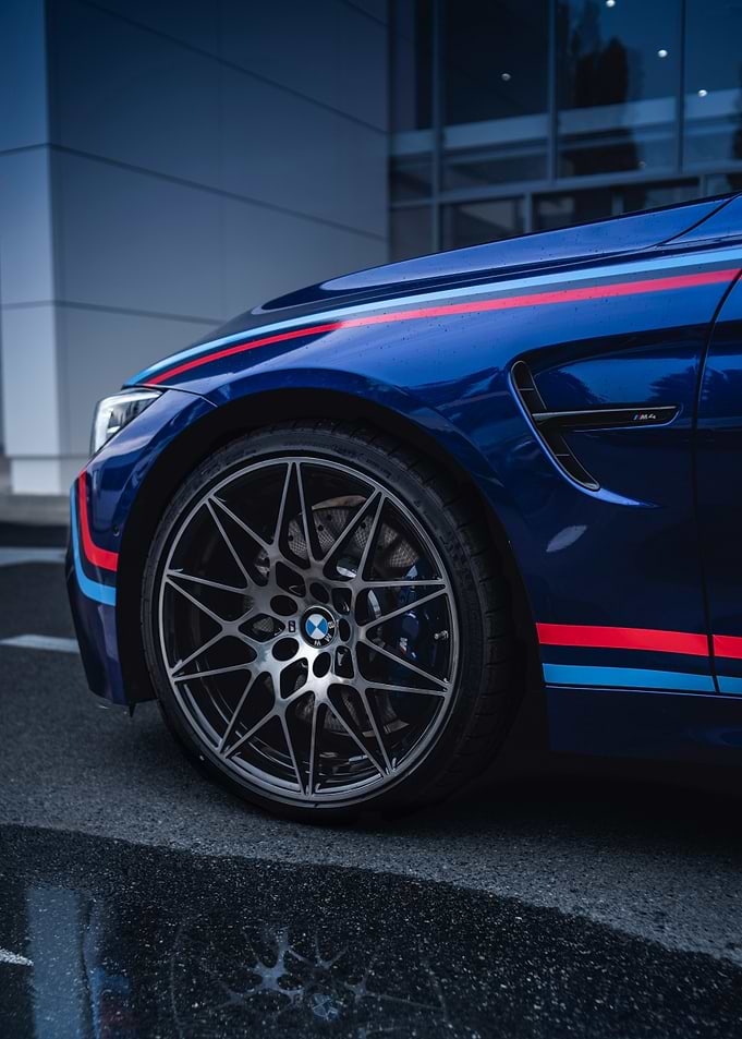 Blue BMW M4 with Racing Stripes