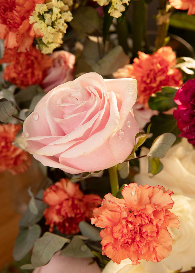 Floral arrangement with pink rose