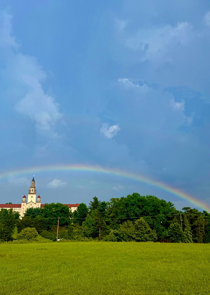 Rainbow over a building and field
