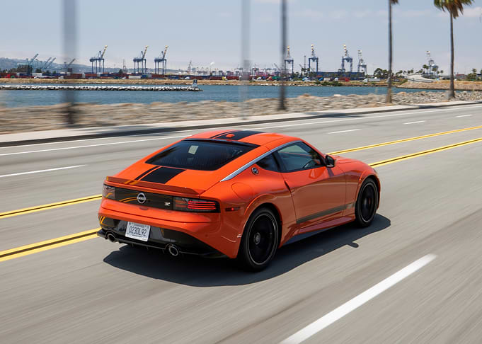 Orange Nissan Z driving on highway