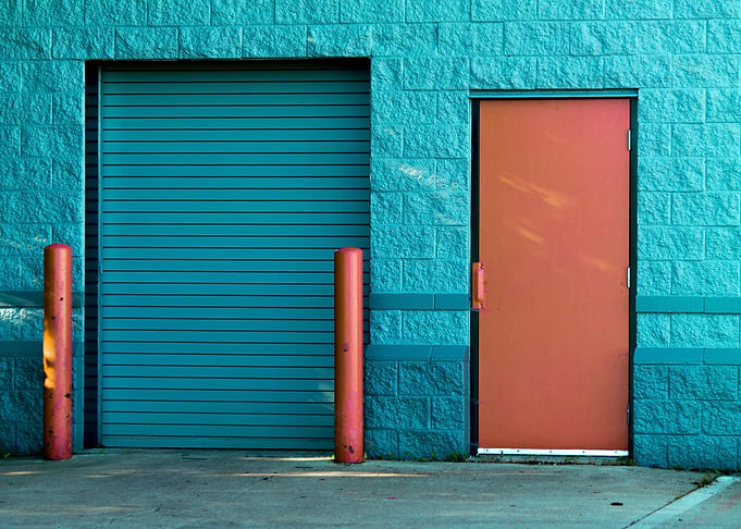 Blue Brick Building with Orange Door