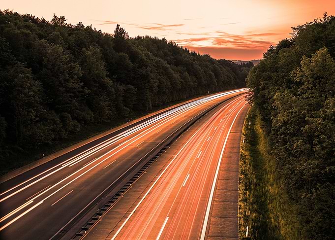 Highway at Sunset with Light Trails