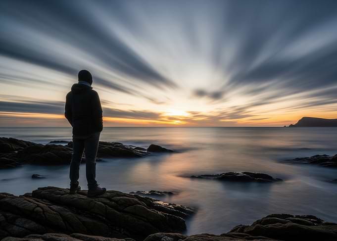 Man Gazing at Ocean Sunset