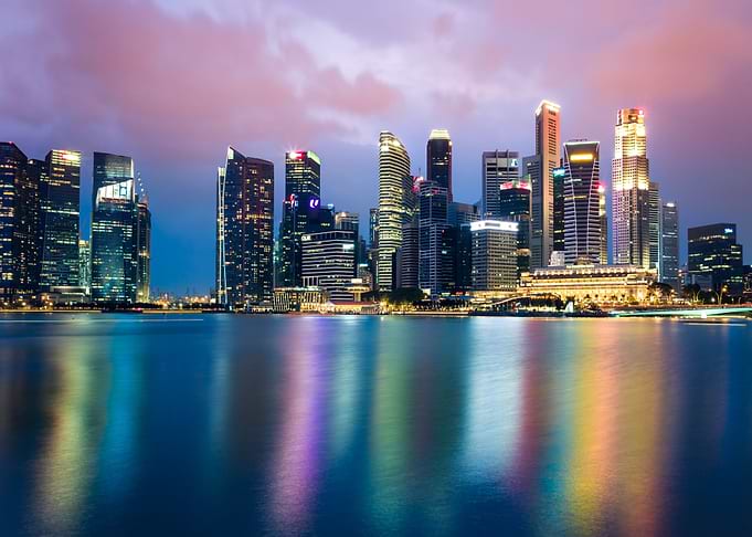 singapore skyline at night with water reflection