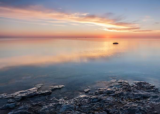 Serene Sunrise Over Calm Waters
