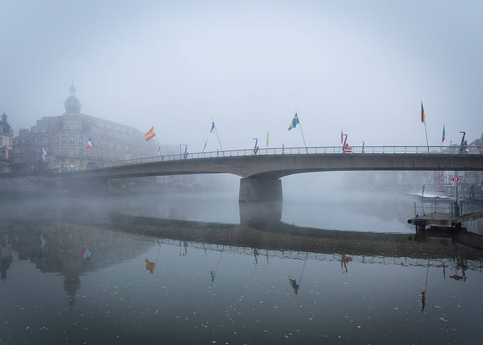Foggy Bridge with Flags over Water