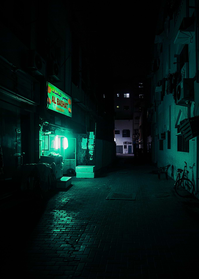 Night alley with green neon light
