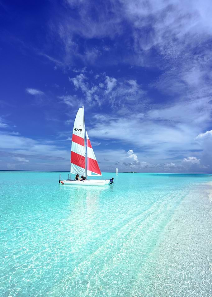 Sailboat on turquoise water under blue sky