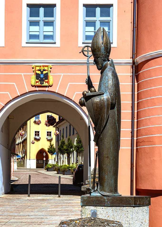 Bronze Statue in Front of Archway