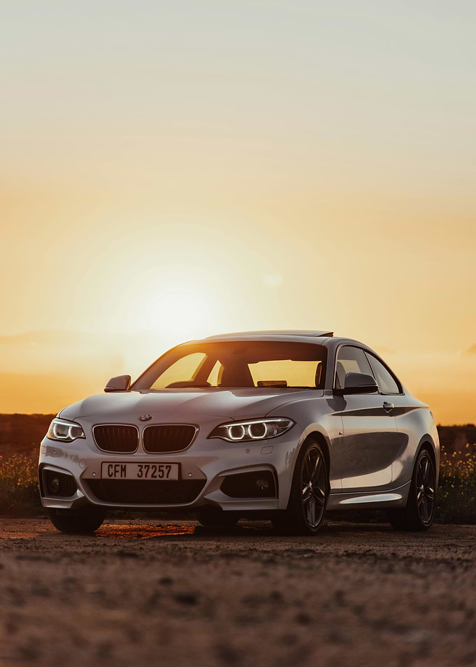 Silver BMW Coupe at Sunset