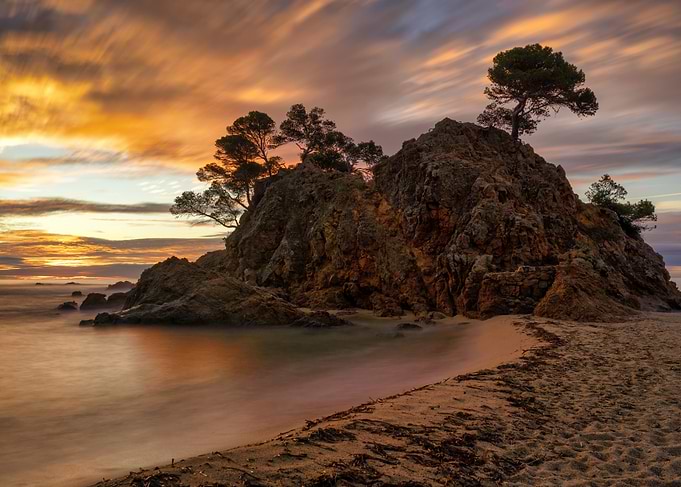 Rocky Island at Sunset Costa Brava Beach Landscape