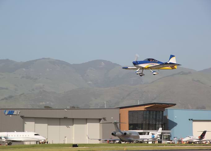 Blue and Yellow Airplane Taking Off
