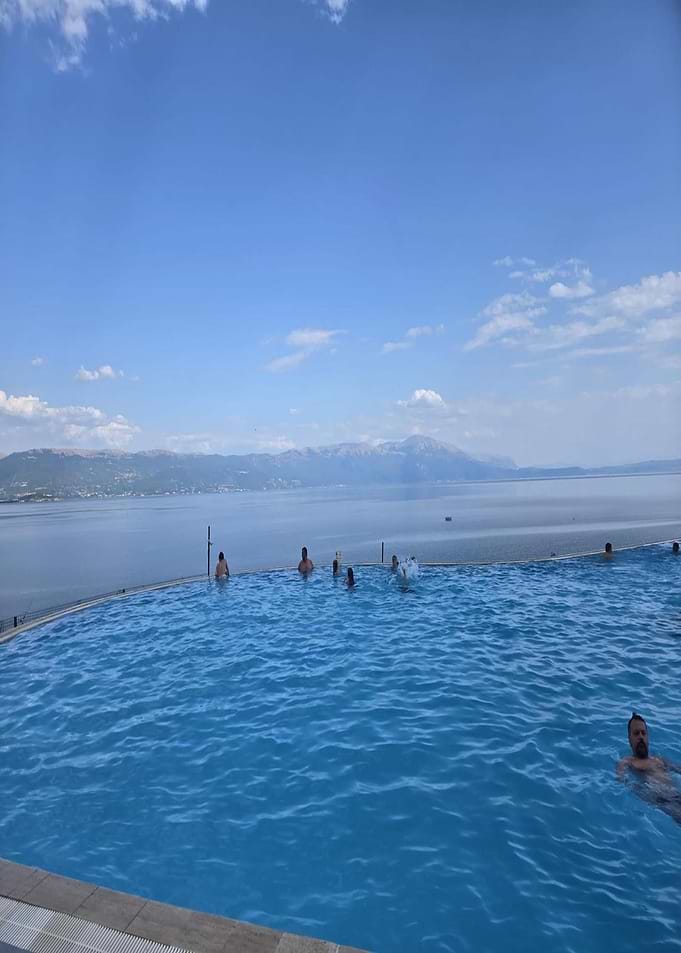 Infinity Pool Overlooking Lake and Mountains
