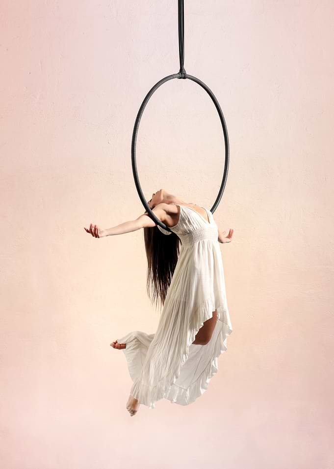 Aerial Hoop Artist in White Dress