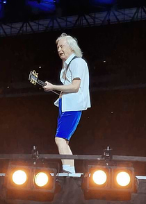 Angus Young performing on stage