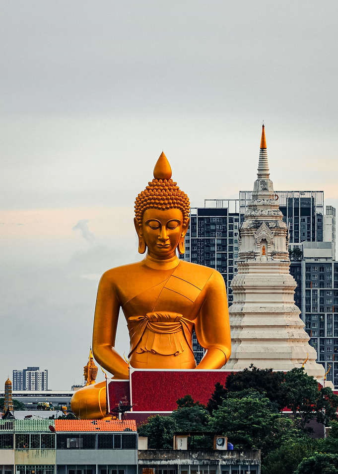 Golden Buddha Statue in Urban Setting