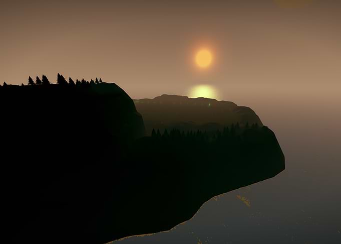 Sunset over a forested coastline