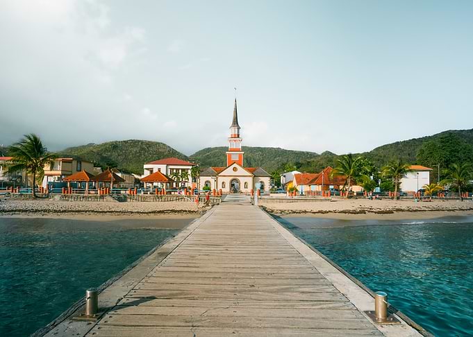 Tropical Pier Leading to Coastal Town