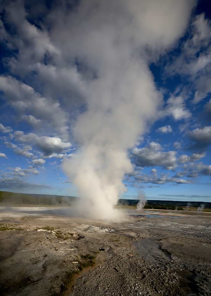 Dramatic Geyser Eruption Under Cloudy Skies