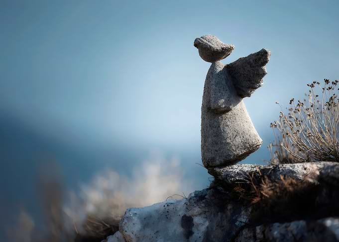 Stone Angel Sculpture on Rocky Ledge