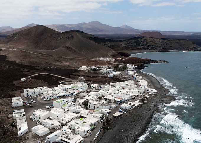 Coastal Village in Volcanic Landscape