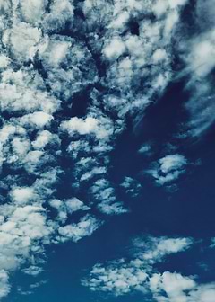 Scattered Clouds with a warm side to it.