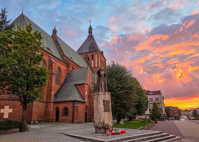 Gothic Cathedral in Koszalin and Statue of John Paul II at Sunset
