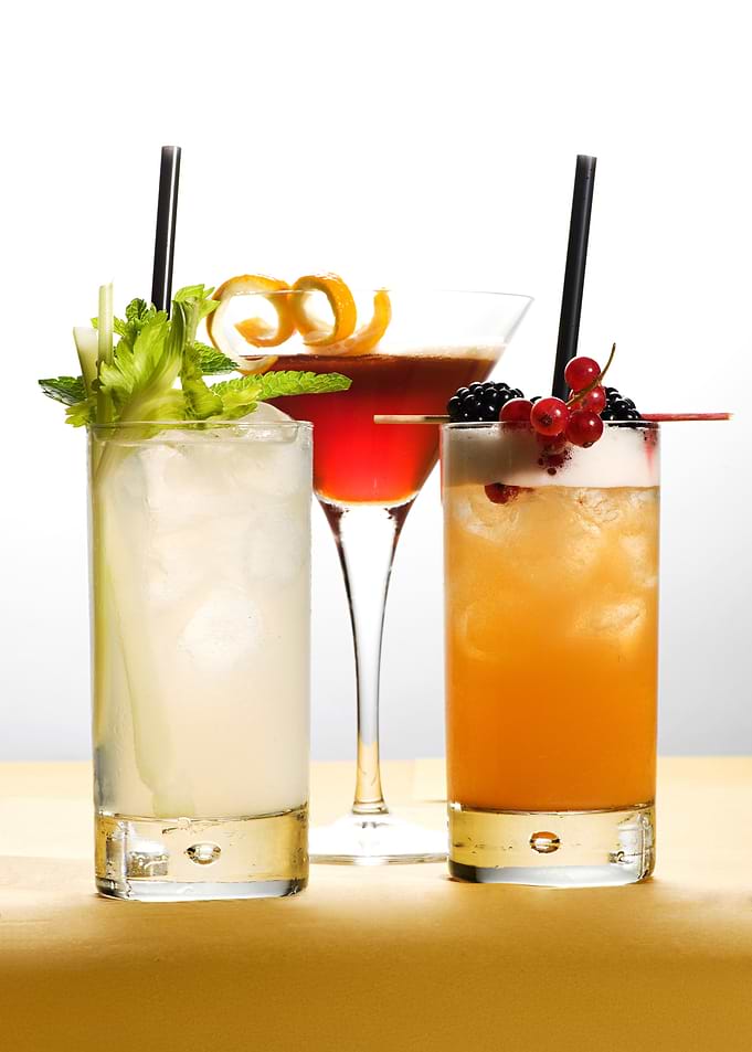 Three colorful cocktails on a table