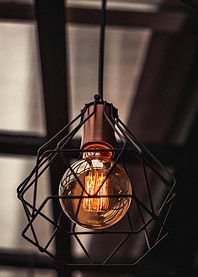 Hanging light bulb with metal cage