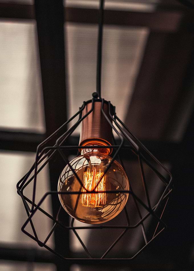 Hanging light bulb with metal cage