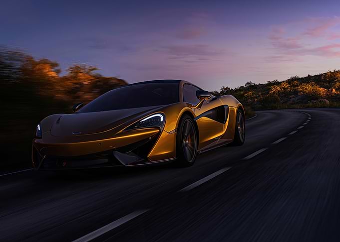 Golden McLaren on a winding road