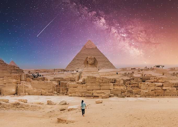 Egyptian Pyramids and Sphinx under starry sky