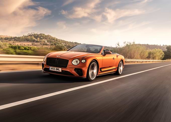 Orange Bentley Convertible on Open Road